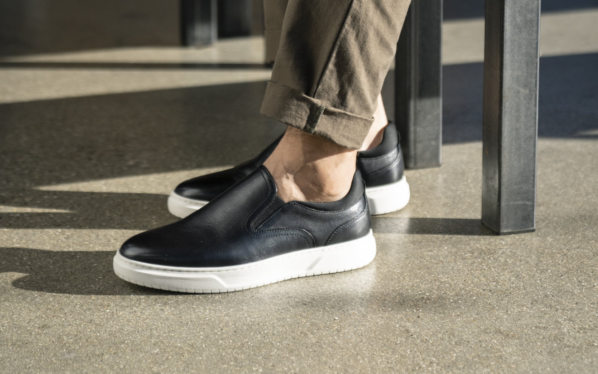 Click to shop the Florshiem Premier collection. Image features the Premier Slip On Sneaker in black.