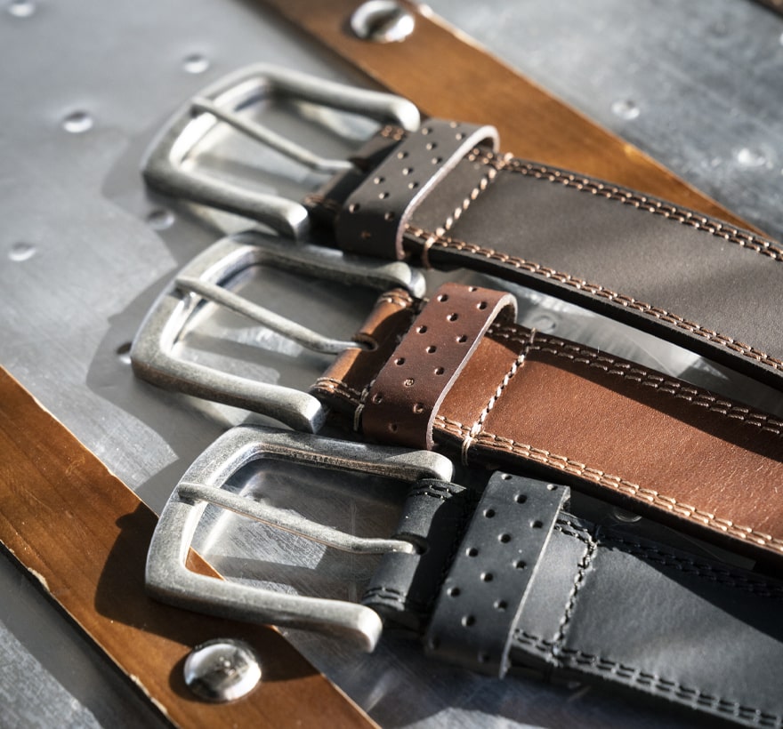 Click to shop Florsheim accessories. Image features a variety of mens belts. 