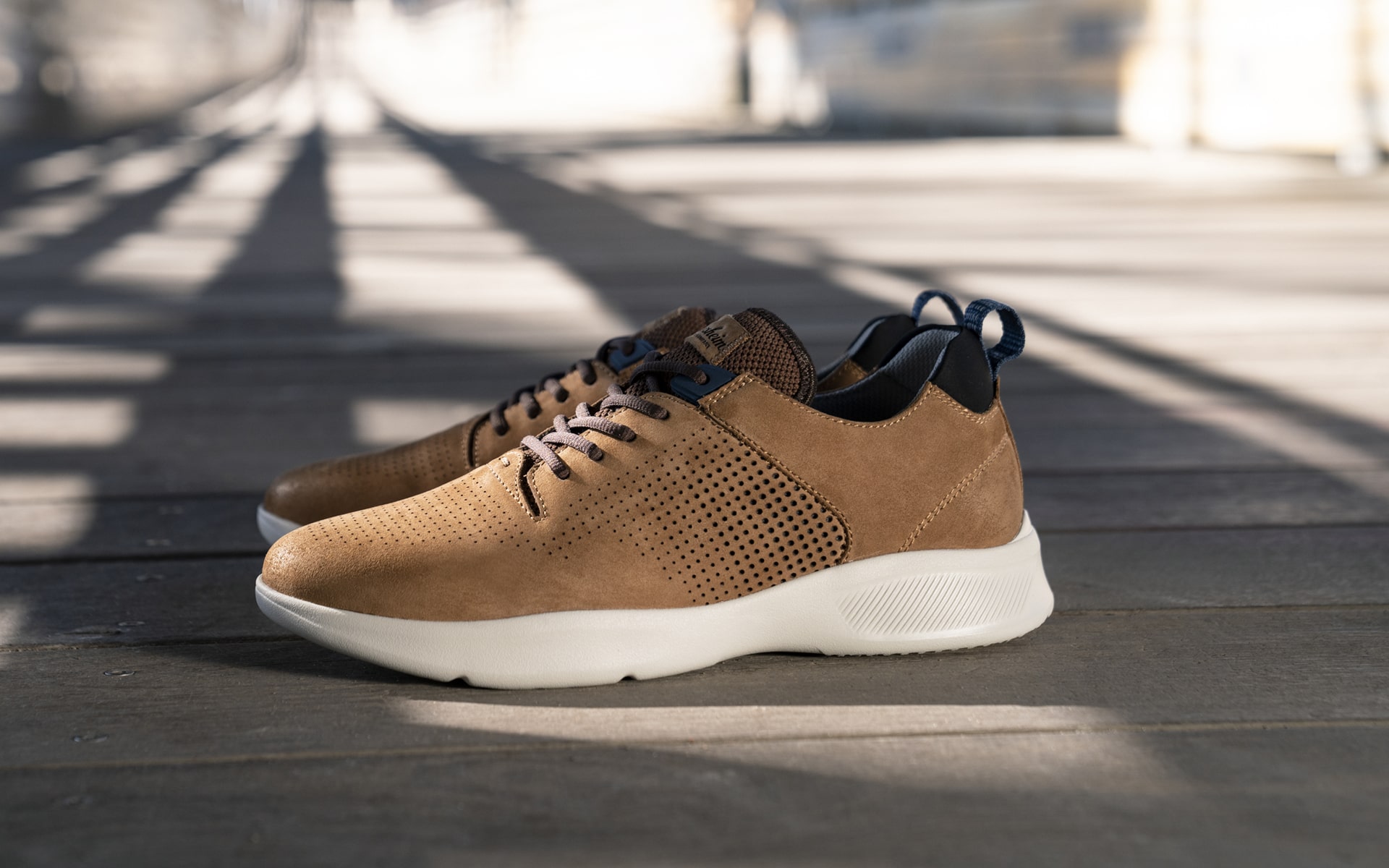 Click to shop the Studio. Image features the Studio sneaker in tan.