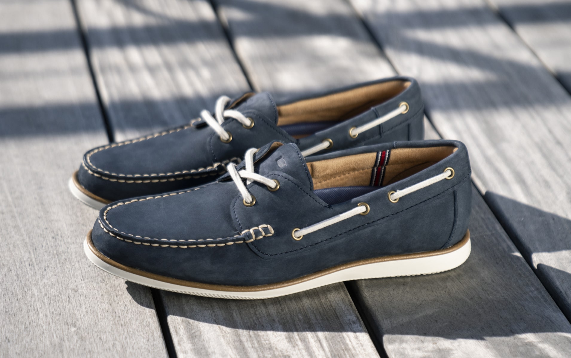 Click to shop Florsheim casual shoes. Image features the Atlantic boat shoe in navy. 