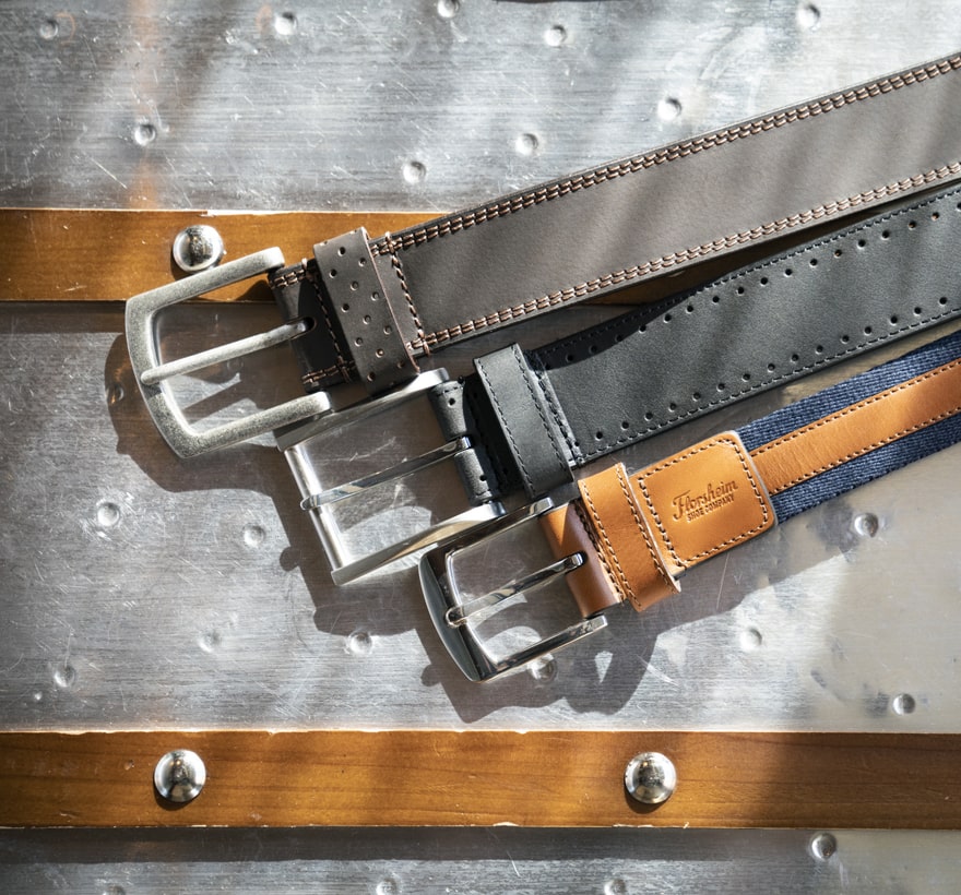 Click to shop Florsheim belts. Image features a variety of Florsheim belts. 