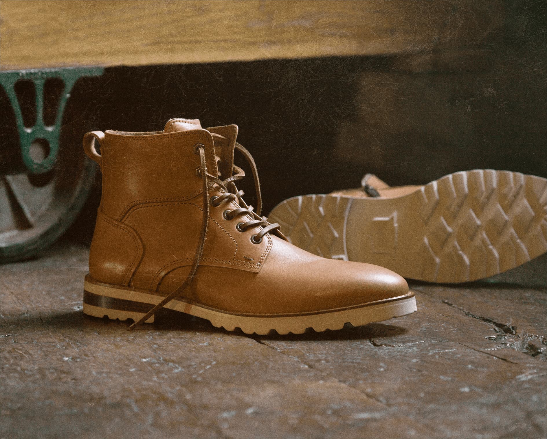 Image features the Renegade Lux boot in veg tan on a distressed wood floor.