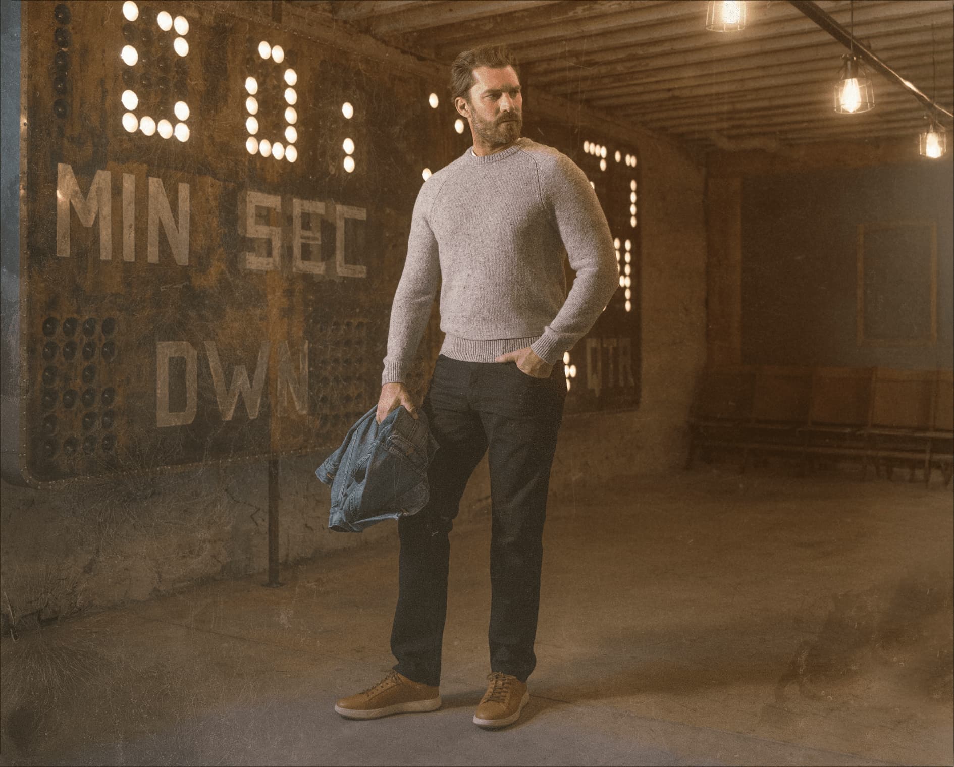 Image features a man in a warehouse wearing the Heist Lux sneaker in veg tan.