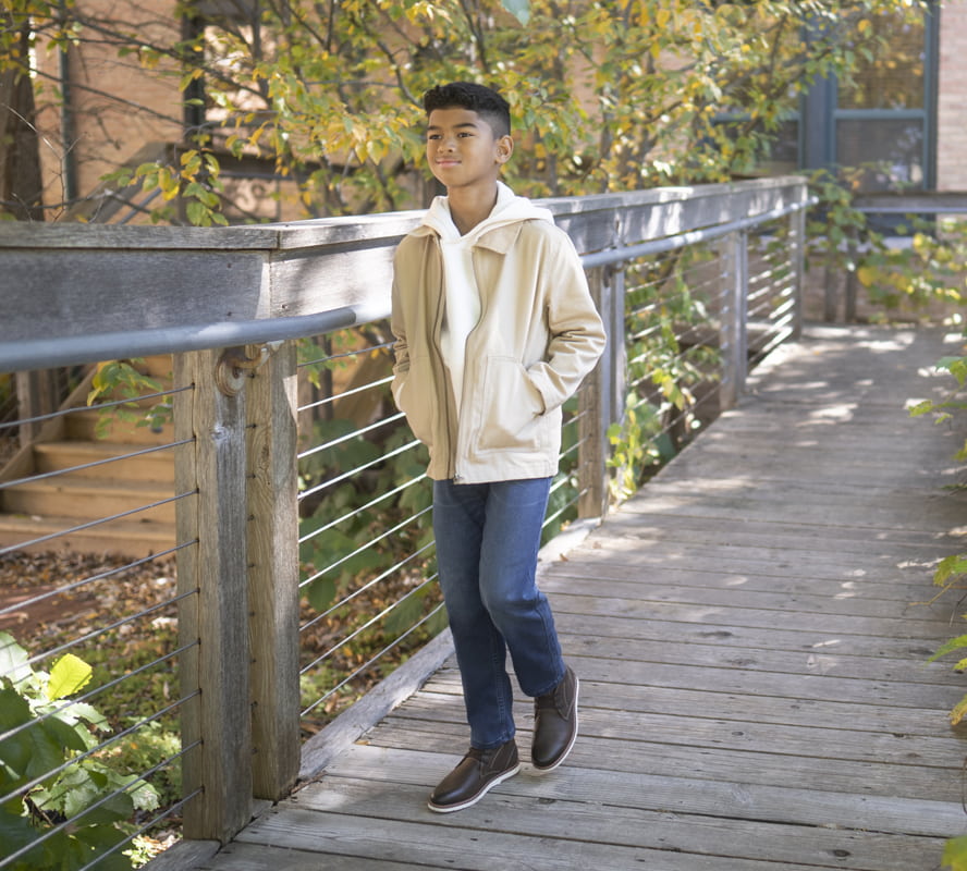 Shop Florsheim Kids featuring the Vibe Jr. Chukka boot on a kids walking on a wooded trail.