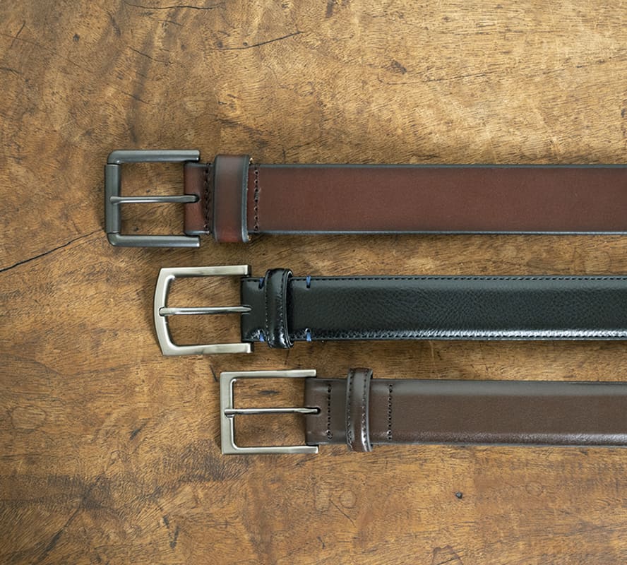 Shop the Florsheim Accessories category featuring Belts on a marbled brown background.
