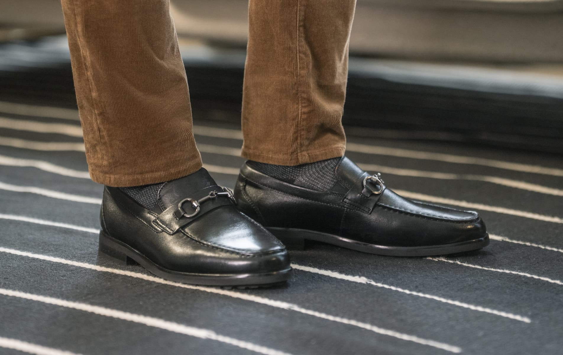 Shop Florsheim's Dress category featuring the Hawthorne Moc Toe Bit Loafer in Black on a striped rug.