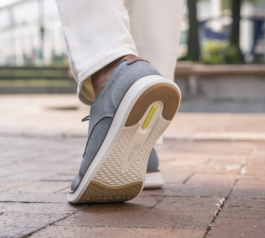 Shop Florsheim Comfortech styles featuring the Comfortech footbed walking on a brick path.