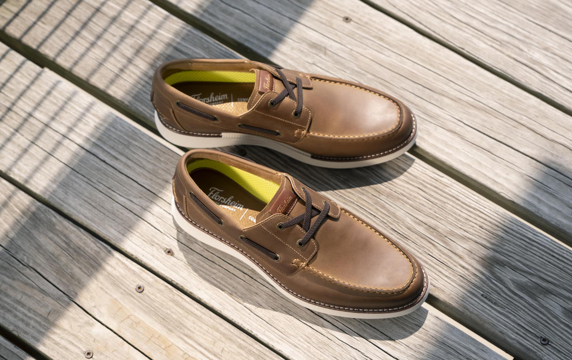 Shop Florsheim casuals featuring a leather boat shoe on a dock.