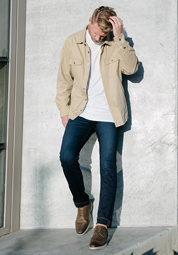 Image of social media influencer Drew Mellon standing outside against a wall while wearing the Flair Wingtip Oxford in Brown Crazy Horse.