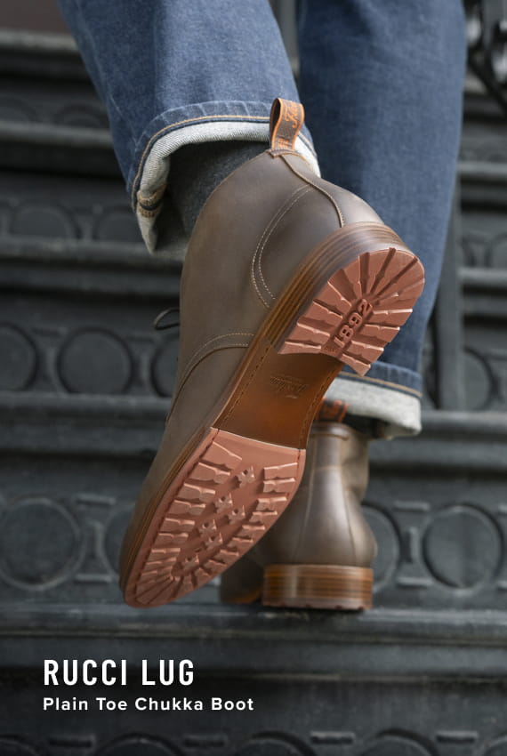  Image features the Rucci Lug Plain Toe Chukka Boot in Brown CH on a staircase.
