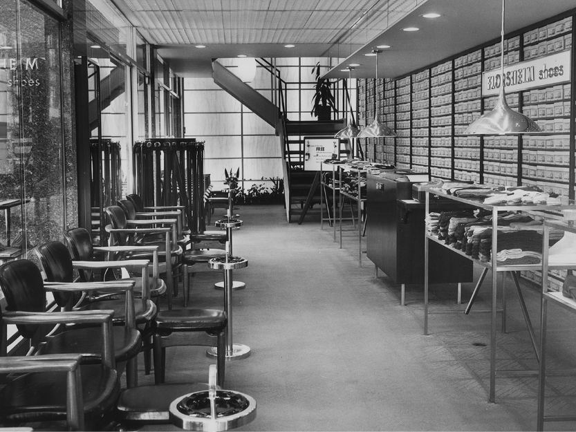 The image shows the interior of a Florsheim retail shoe store in 1949.
