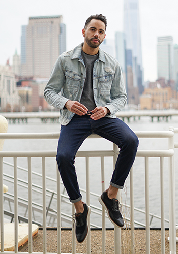 Image of social media influencer Victor Lopez wearing the Fuel Knit Wingtip Oxford while sitting on a railing.