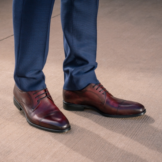 "How To Clean Shoes: Follow These Cleaning Tips For The Best Results." The featured product is the Amelio Cap Toe Oxford in Burgundy.