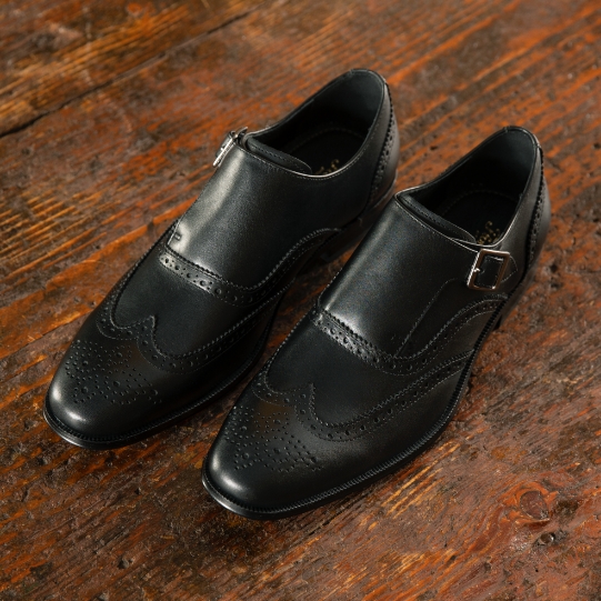 "Why Men’s Black Shoes Are A Wardrobe Must-Have." The featured product is the Jetson Wingtip Monk Strap in Black.