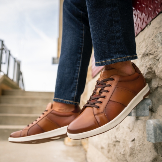 "Online Shopping? The Best Deals Are Just A Click Away." The featured product is the Crossover Lace To Toe Sneaker in Cognac.