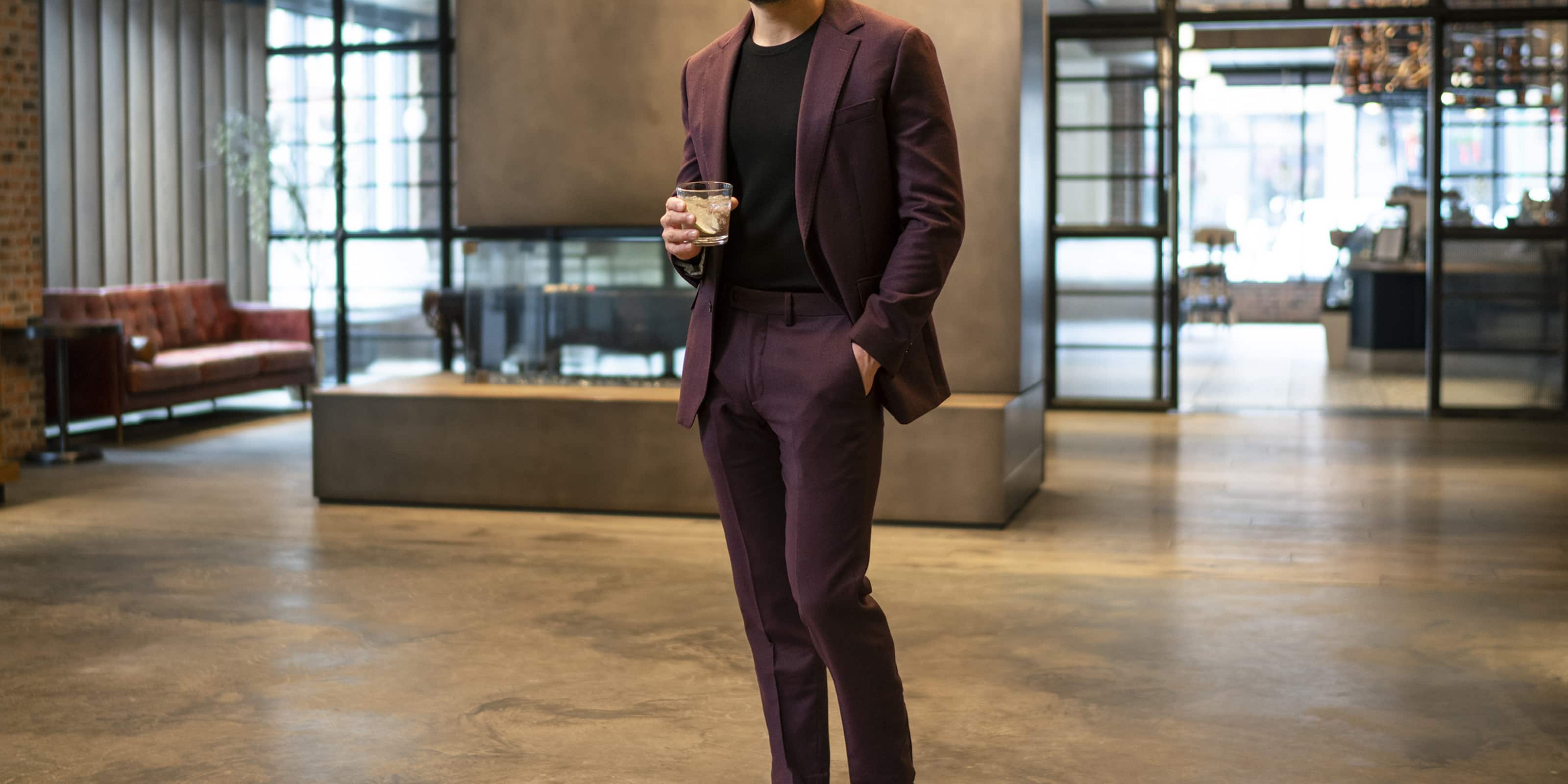 The featured image is a model wearing a burgundy suit.