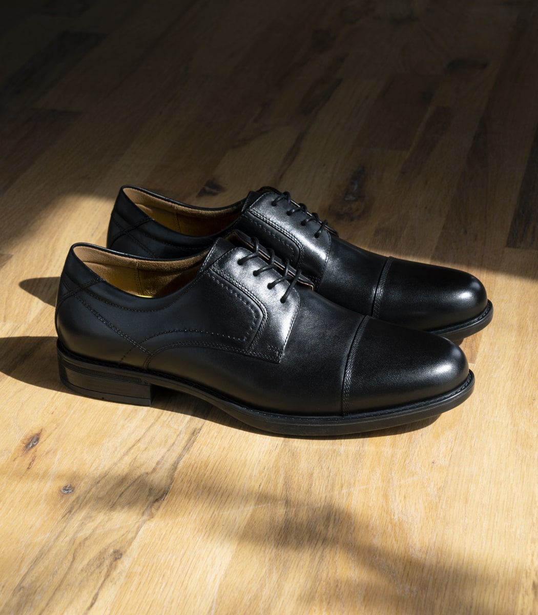 The featured product is the Midtown Cap Toe Oxford in Black.