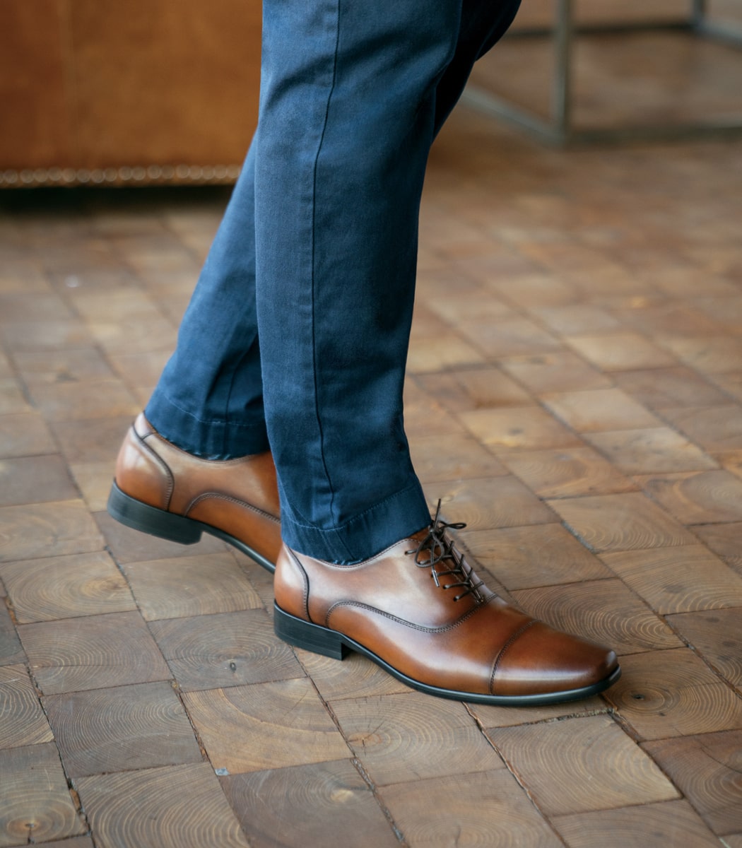 The featured image is a man wearing the Midtown Cap Toe Oxford in Cognac.