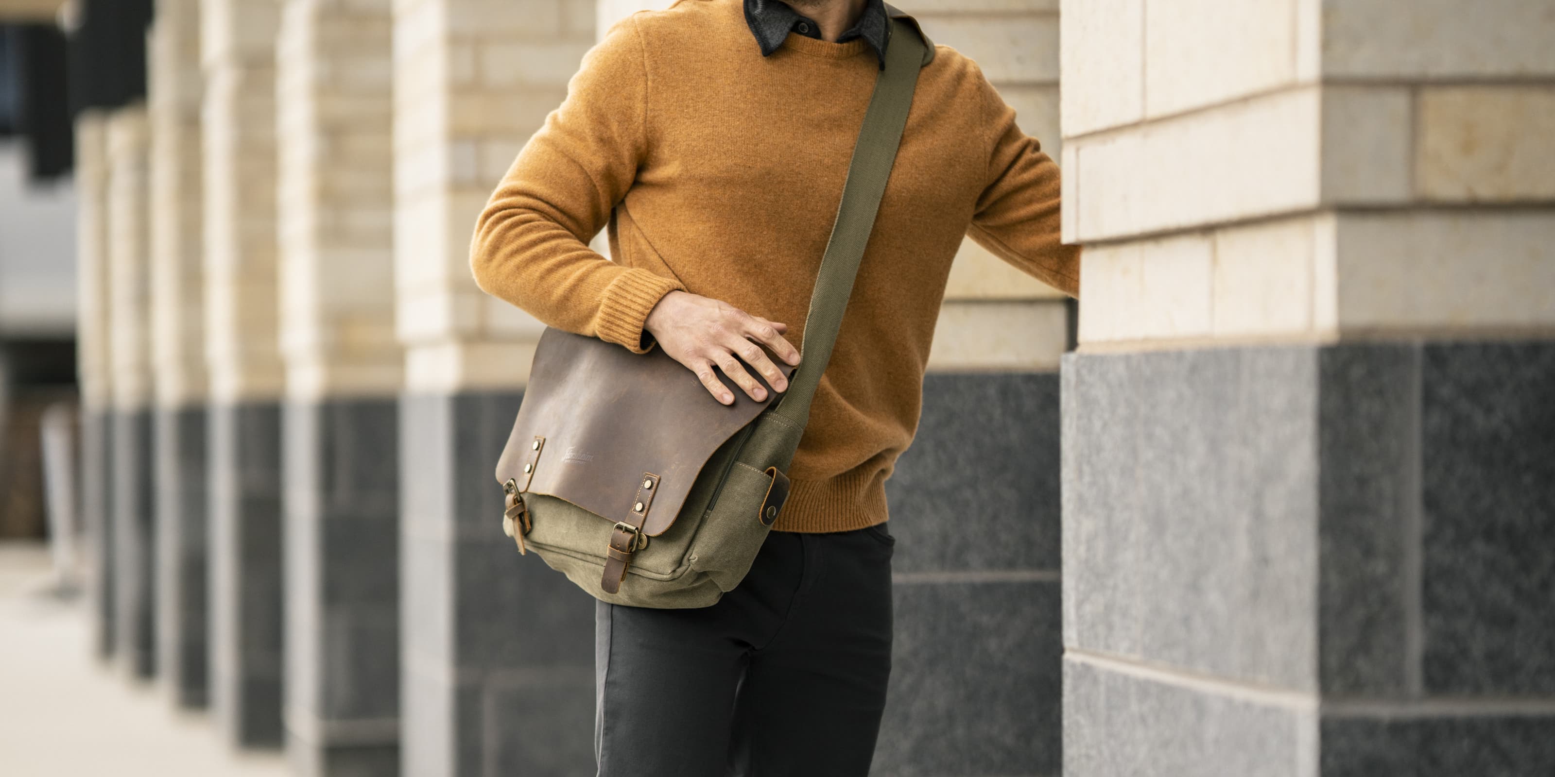 The featured image is a model opening a door while wearing a stylist sweater and crossbody bag.