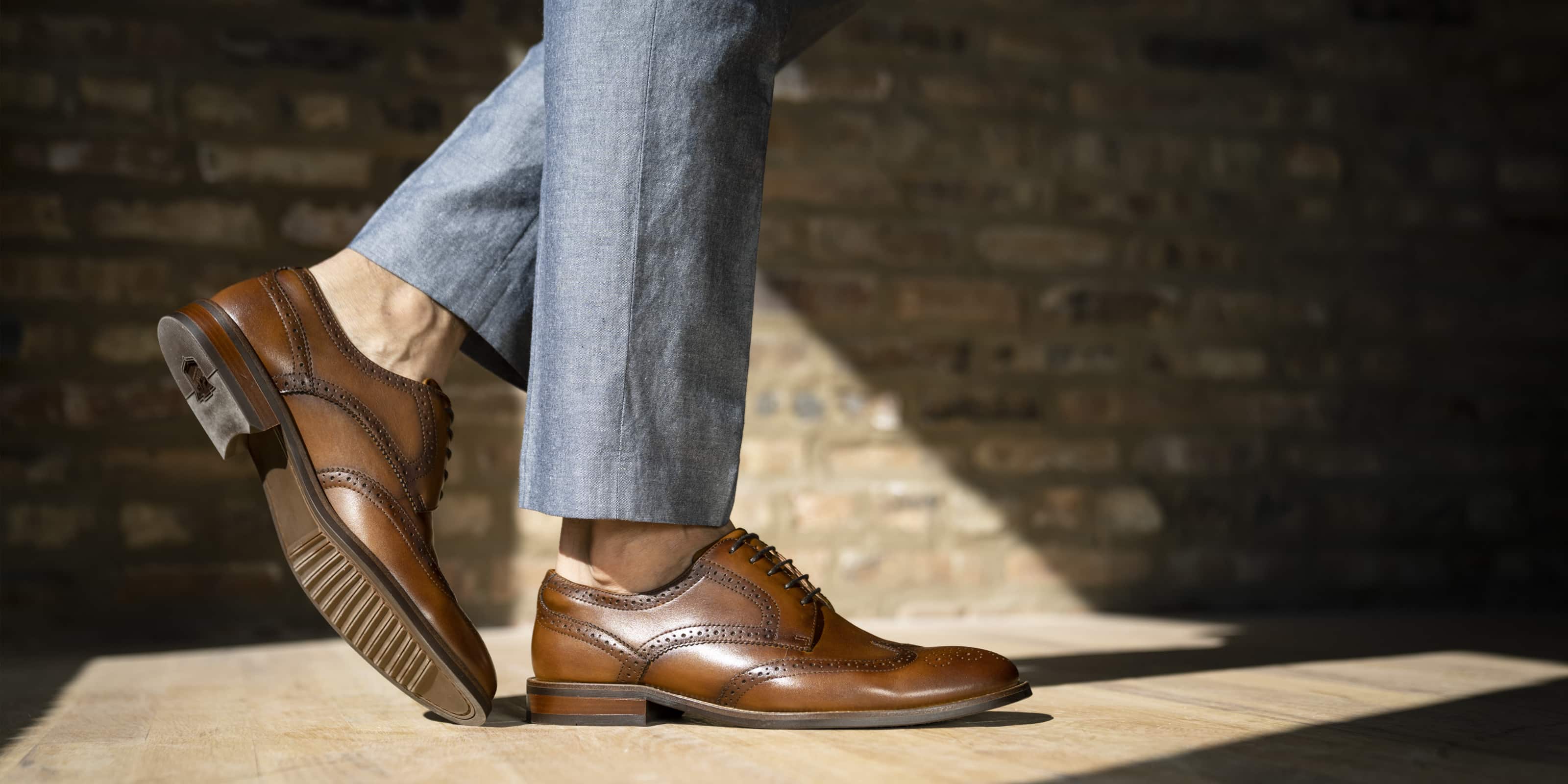 The featured image is a man wearing the Rucci Wingtip Oxford in Cognac.