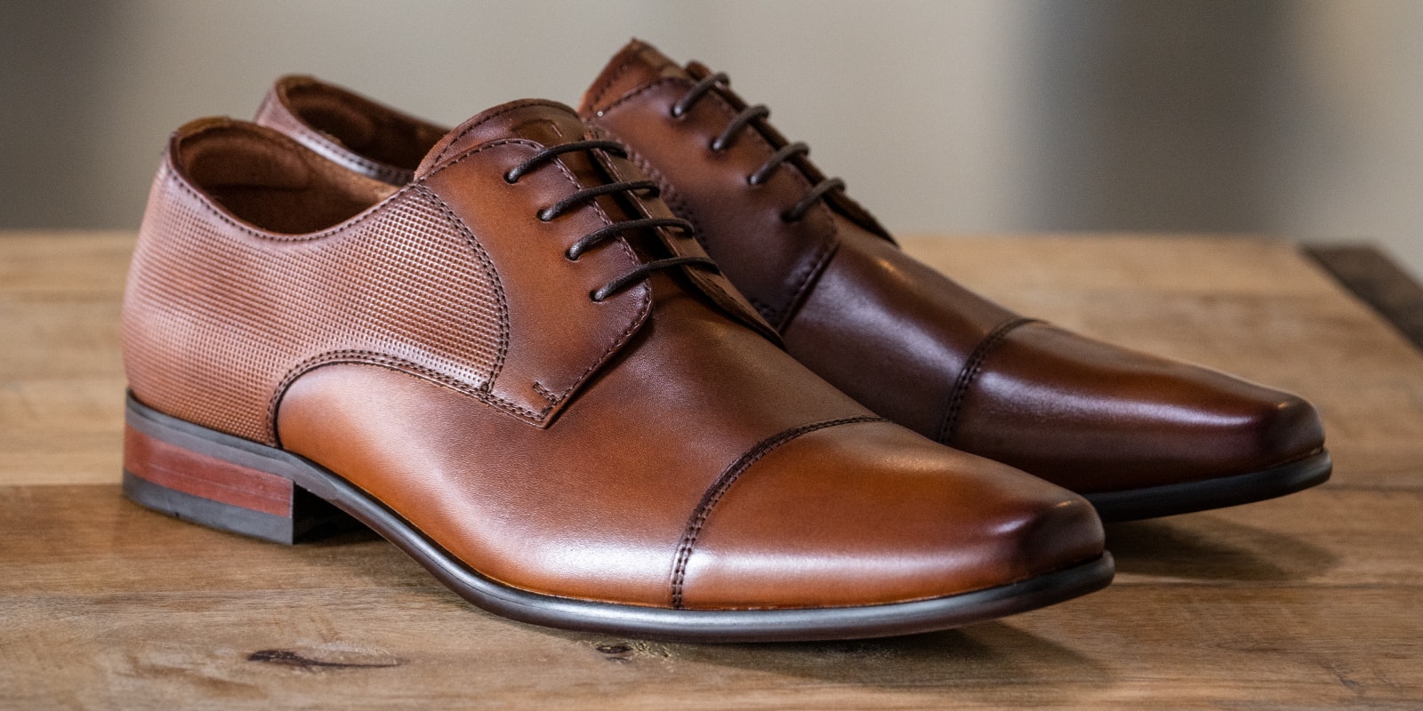 The featured product is the Postino Cap Toe Oxford in Cognac.