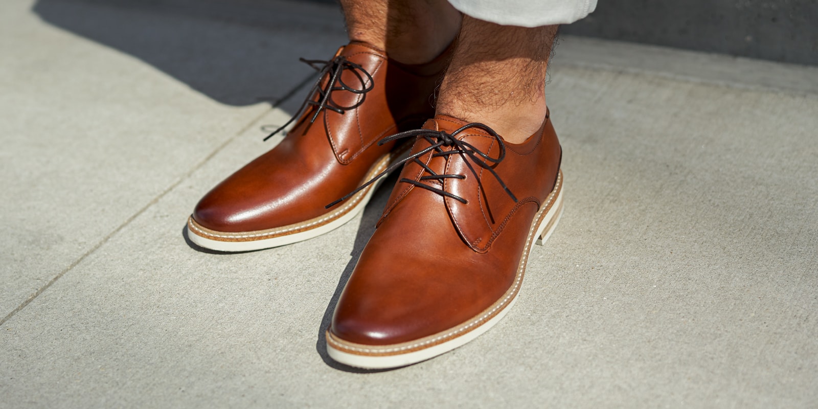 The featured product is the Highland Plain Toe Oxford in Cognac.