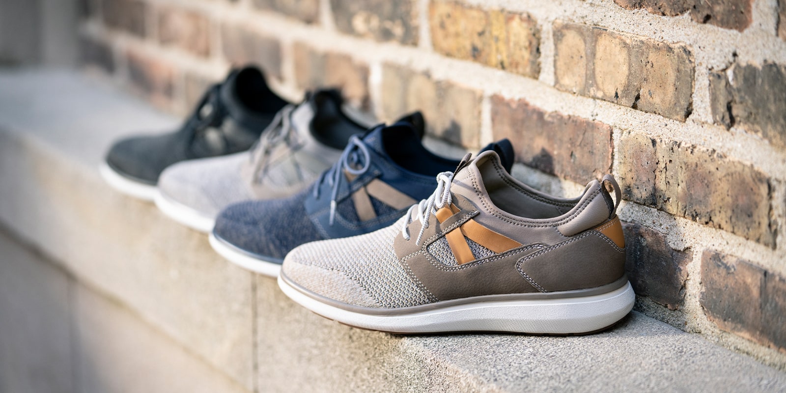 The featured products are the Venture Knit Plain Toe Lace Up Sneakers in Mushroom, Navy, Gray, and Black.